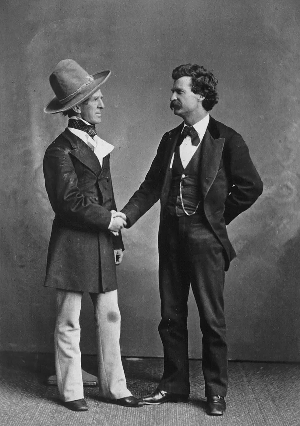 Mark-Twain-in-a-handshake-with-John-T.-Raymond-the-actor-who-played-Colonel-Sellers-in-the-stage-adaptation-of-Twains-The-Gilded-Age